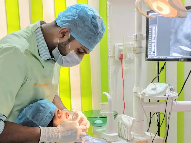 Dentist treating a patient at Genus Dental, Lucknow
