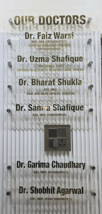 Our Doctors board at Genus Dental listing doctors and qualifications